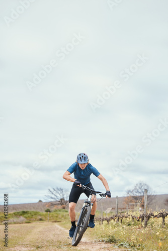 Exercise, man and cycling for fitness, bike and training with wellness, helmet for safety and health. Male person, athlete or cyclist with action, race and adrenaline junkie with adventure and travel