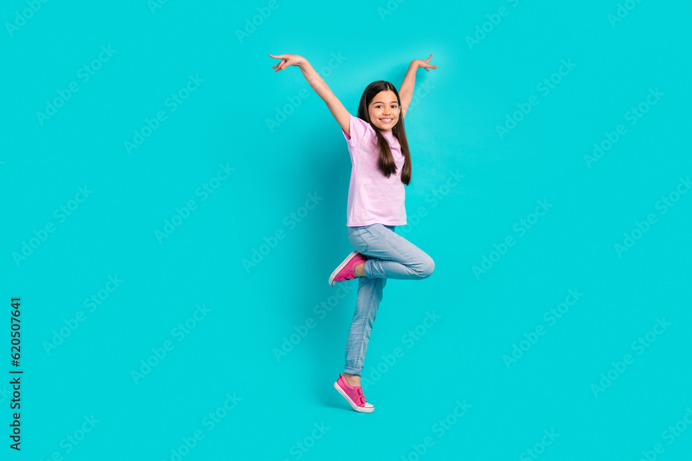 Full size photo of funny small girl hands up wings balance careless chill feel lightness freedom isolated on aquamarine color background