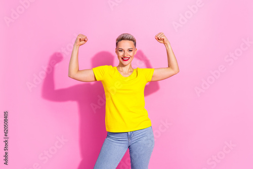 Portrait of pretty girl toothy smile arms showing flexing biceps muscle isolated on pink color background
