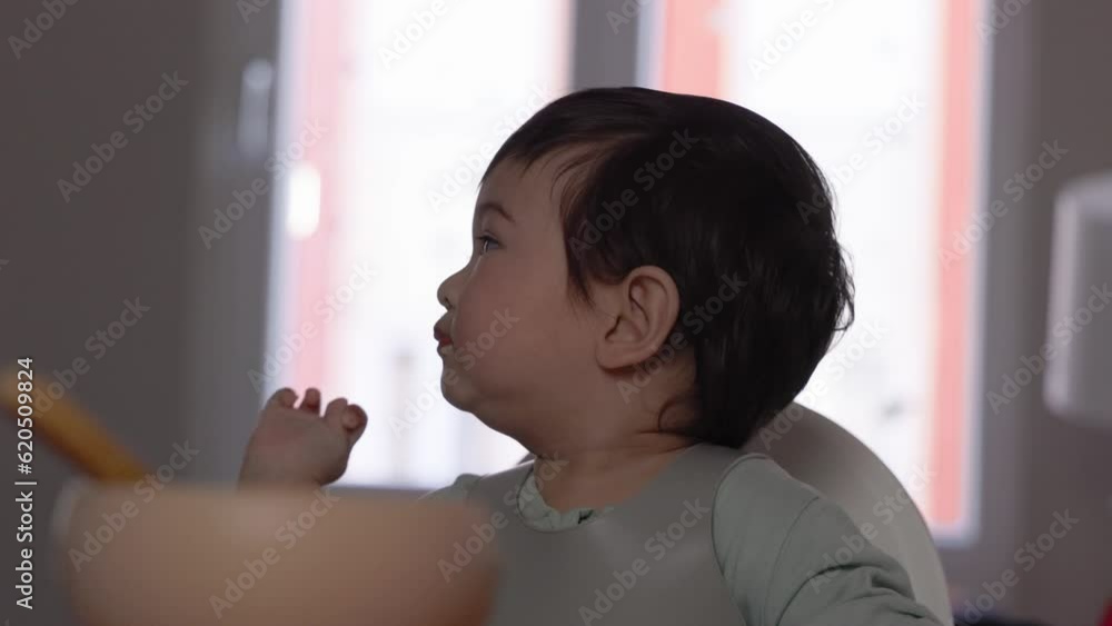 Mom spoon-feeds her baby. Introduction of complementary food, good nutrition, baby food Mom spoon-feeds her baby. Introduction of complementary food, good nutrition, baby food