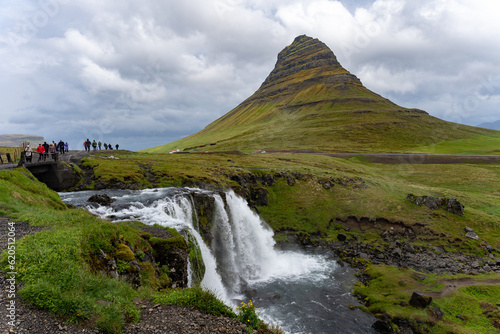 Kirkjufell, Iceland - 06.23.2023: Kirkjufell Mountain and Kirkjufellsfoss waterfall in Iceland