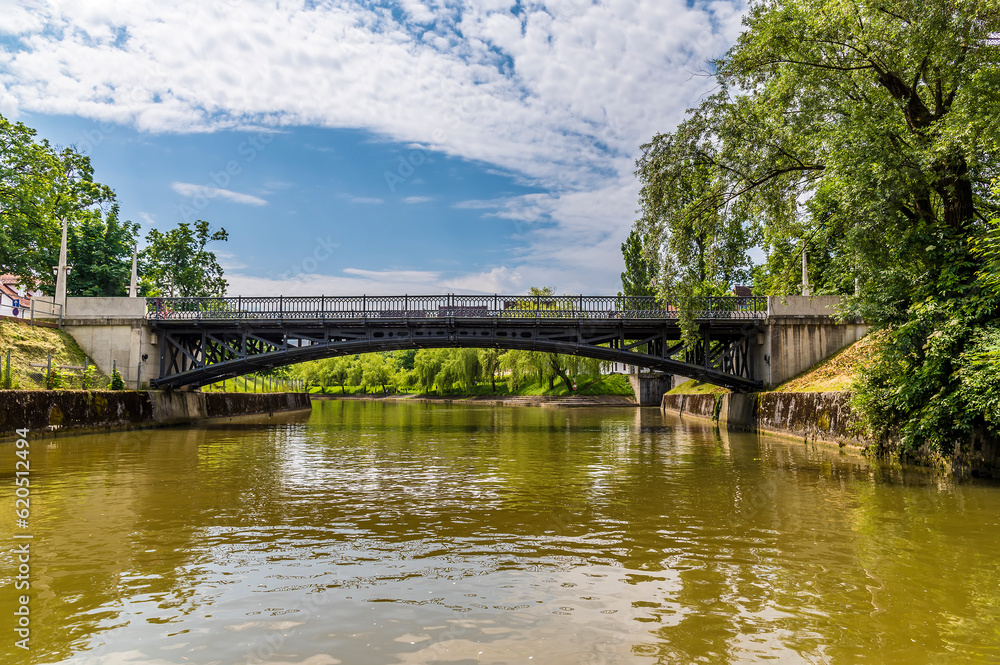 A close up view of the Mortuary Bridge over the Ljubljanica River; the first and only cast iron, hinged bridge in Slovenia in summertime