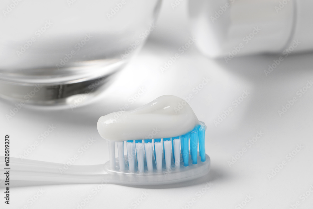 Plastic toothbrush with paste on white background, closeup Plastic toothbrush with paste on white background, closeup