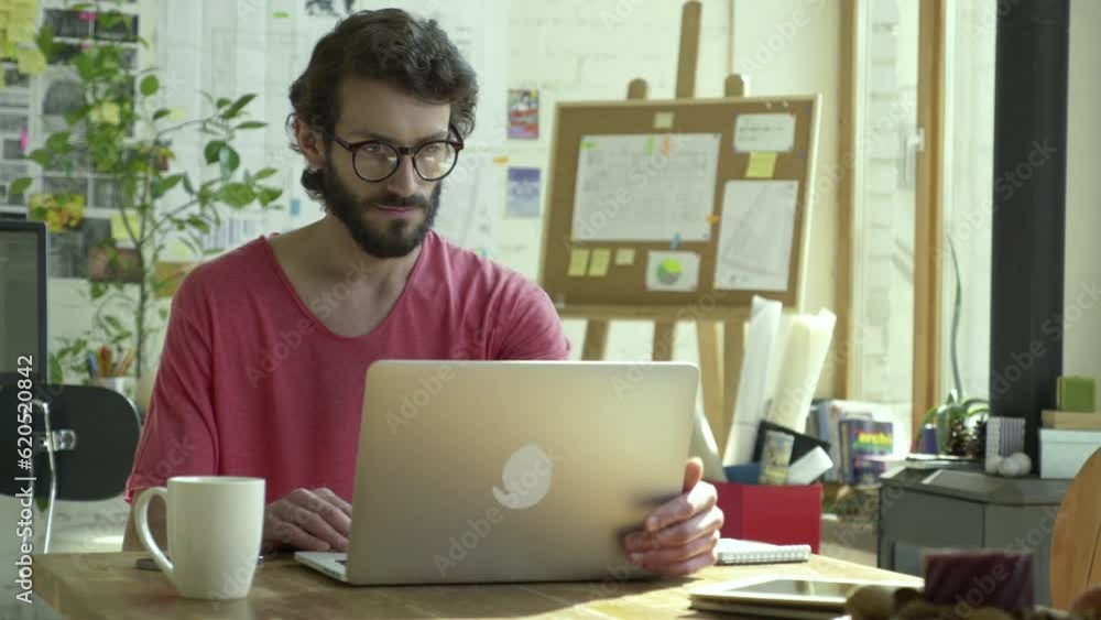 He is ready for a productive working day beginning. He sits near table and open his laptop computer for turn on. He does a few actions with device, type in some information and finish his work. He is ready for a productive working day beginning. He sits near table and open his laptop computer for turn on. He does a few actions with device, type in some information and finish his work.