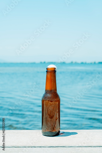 open beer bottle on a pier