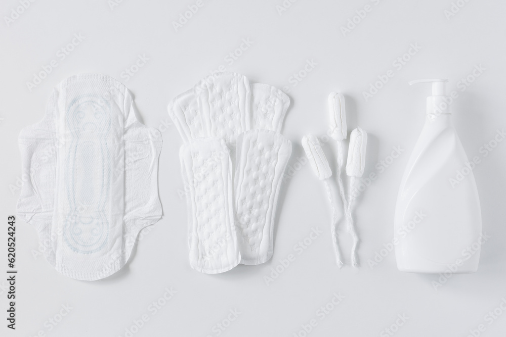 Tampons, feminine cotton sanitary pads and liquid intimate soap on a white background Tampons, feminine cotton sanitary pads and liquid intimate soap on a white background