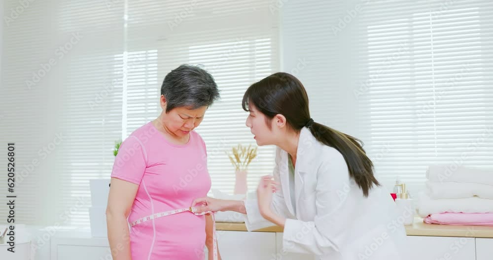 physician measure woman waist physician measure woman waist