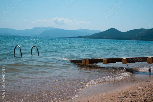 Fototapeta Naklejka Na Ścianę i Meble -  A wheelchair-accessible beach in Palairos, Greece. Designed with thoughtful accessibility features including ramps, pathways, and specialized beach wheelchairs, it provides equal access.