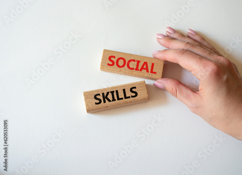 Social skills symbol. Wooden blocks with words Social skills Beautiful white background. Businessman hand. Business and Social skills concept. Copy space.