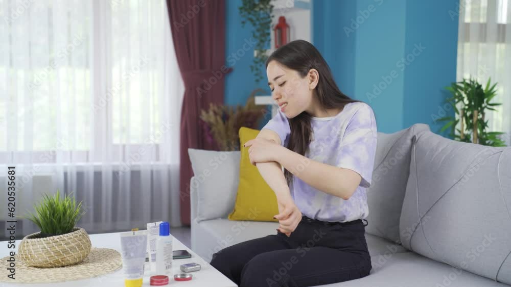 Young Asian girl applying cream to her painful areas. Young Asian girl applying cream to her painful areas.