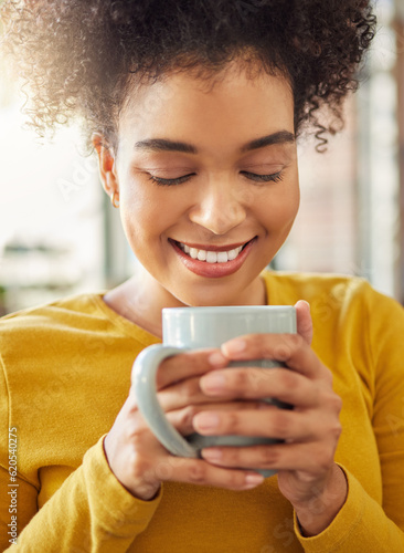 African woman, coffee cup and smile in home, scent and energy to start morning in apartment. Girl, happy and drink to relax with cocoa, matcha and espresso with fragrance, thinking and mug in house