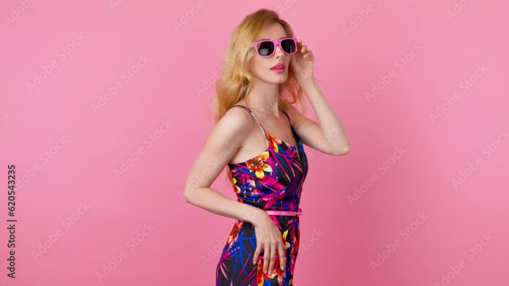 Dancing excited fashionable woman having fun rhythm to music, enjoying life, entertainment. Carefree playful smiling sexy lady, trend makeup, colorful floral outfit for ad, fashion, party on pink Dancing excited fashionable woman having fun rhythm to music, enjoying life, entertainment. Carefree playful smiling sexy lady, trend makeup, colorful floral outfit for ad, fashion, party on pink