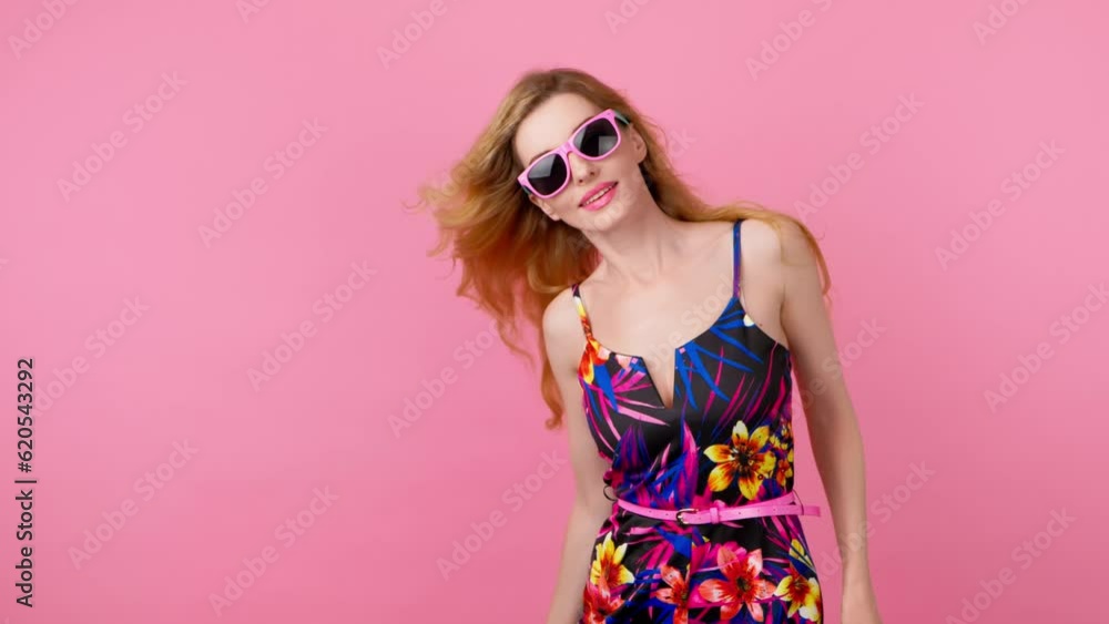 Dancing excited fashionable woman having fun rhythm to music, enjoying, entertainment. Carefree playful smiling sexy lady, trend makeup, colorful floral outfit for ad, fashion, party on pink. Reverse Dancing excited fashionable woman having fun rhythm to music, enjoying, entertainment. Carefree playful smiling sexy lady, trend makeup, colorful floral outfit for ad, fashion, party on pink. Reverse