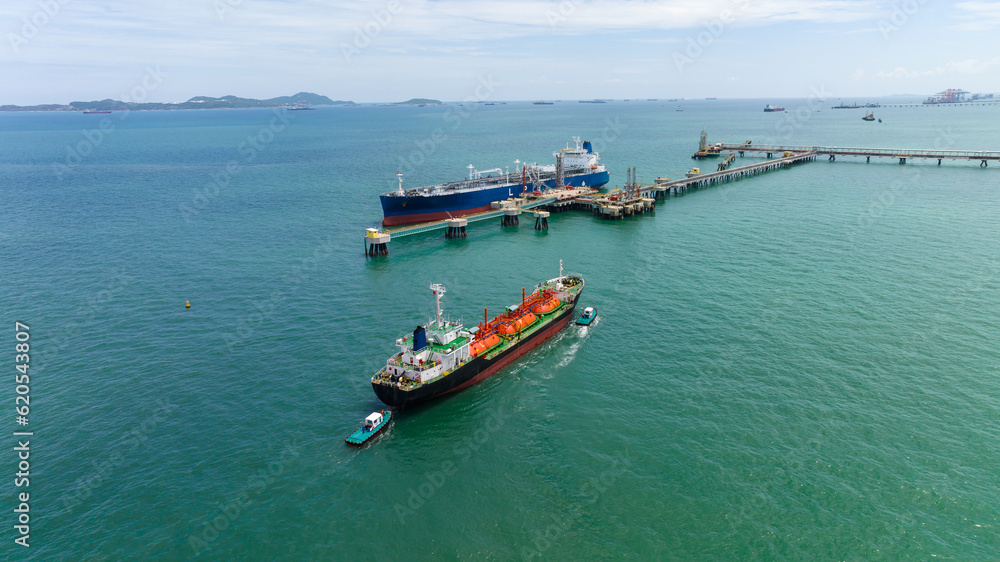crude oil floating station in sea, bridge pipeline load unloading crude oil from oil ship transport, industry business transportation by container ship open sea,
