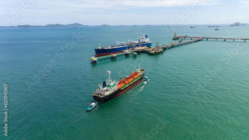 crude oil floating station in sea, bridge pipeline load unloading crude oil from oil ship transport, industry business transportation by container ship open sea,