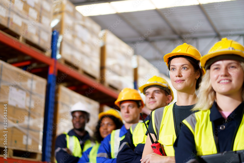 Portrait of a group of warehouse employees standing in the warehouse together. Portrait of a group of warehouse employees standing in the warehouse together.