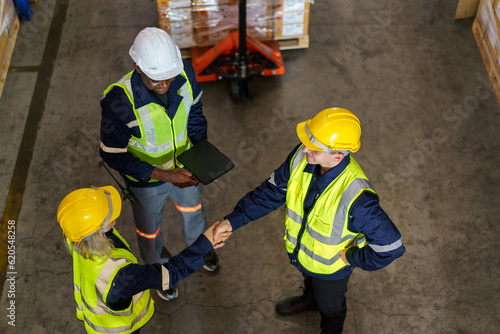 Diversity ethnicity of warehouse staff or engineer making a discussion together before start working, team of engineer in factory making a morning brief before working.