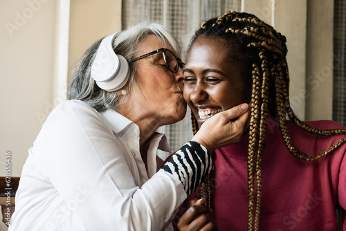 Multi generational women having tender moment at home - Care giver enjoying time with elderly senior female