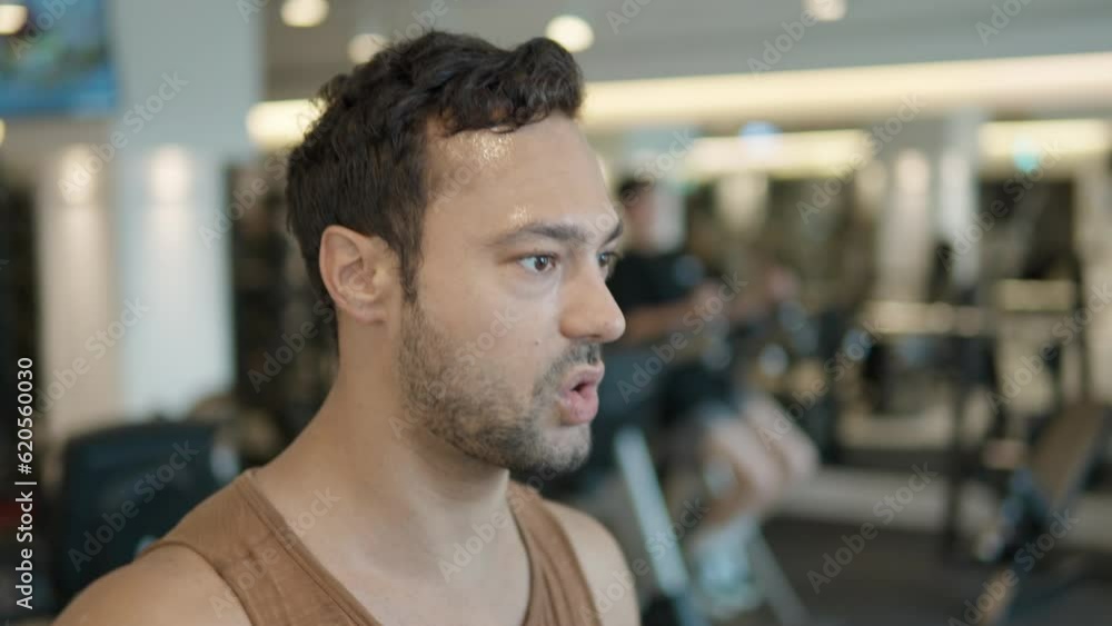Portrait Of Fit Man Running On Treadmill In Gym and Breathing Heavily. Close-up view of active, caucasian male with bad endurance having intensive cardio workout to burn calories Portrait Of Fit Man Running On Treadmill In Gym and Breathing Heavily. Close-up view of active, caucasian male with bad endurance having intensive cardio workout to burn calories