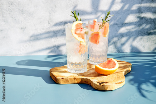 Obraz na płótnie Chilled drink with fresh citrus fruits and rosemary