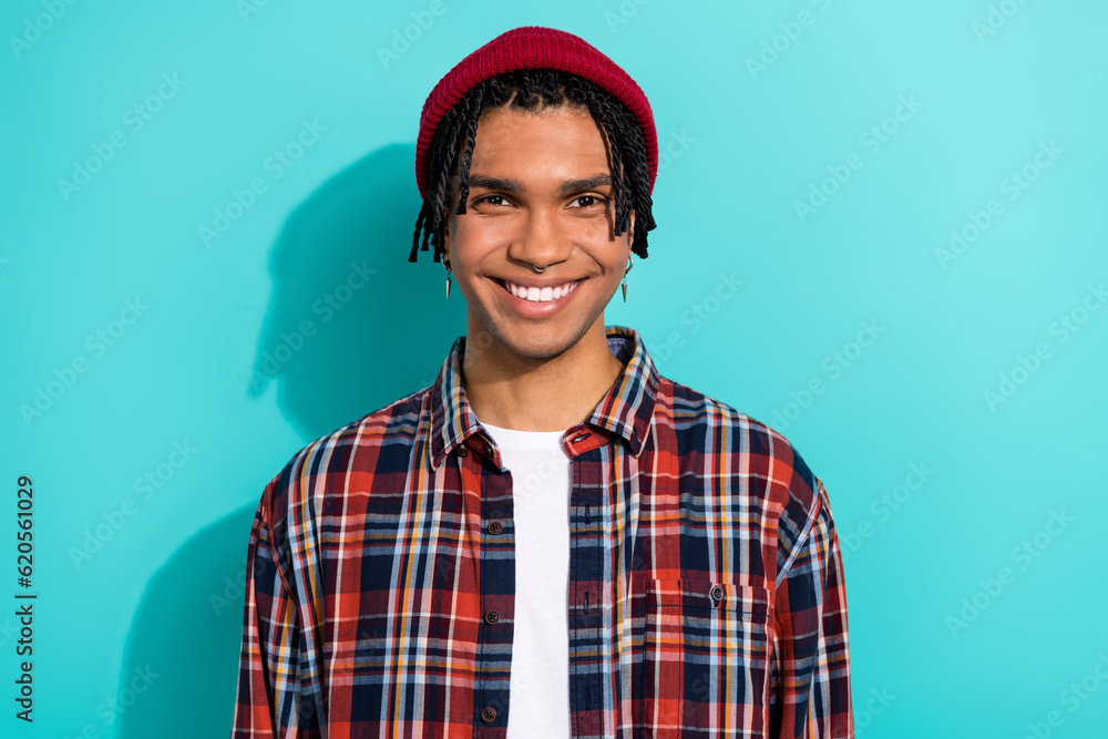 Photo portrait of nice young guy toothy beaming smile model stomatology dressed stylish checkered clothes isolated on cyan color background Photo portrait of nice young guy toothy beaming smile model stomatology dressed stylish checkered clothes isolated on cyan color background