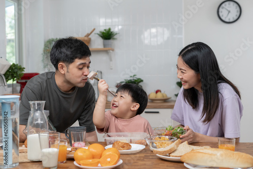 activities together during the holidays. Parents and children are having a meal together during the holidays. New home for family on morning  enjoy  weekend  vacant  family time  happy.