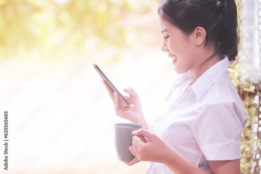 Asian businesswoman holding a cup of coffee relaxing in the office. Asian businesswoman holding a cup of coffee relaxing in the office.