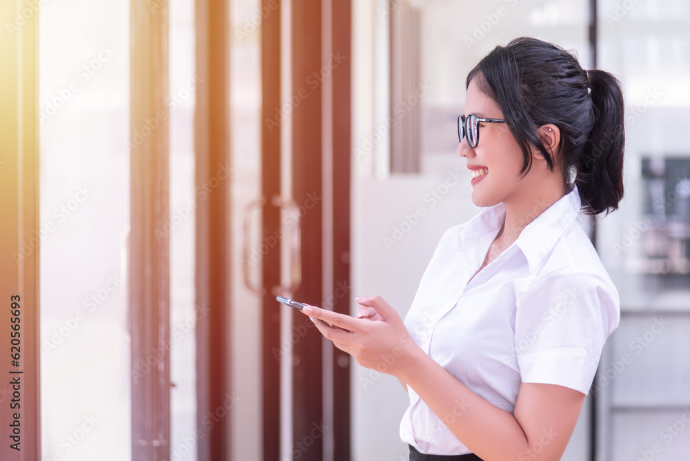 Asian businesswomen used smartphone in the office. Asian businesswomen used smartphone in the office.