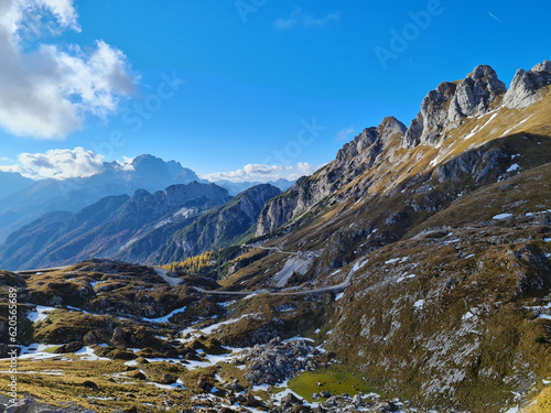 Alpine road over meadows under rocky peaks © EDolzan photography