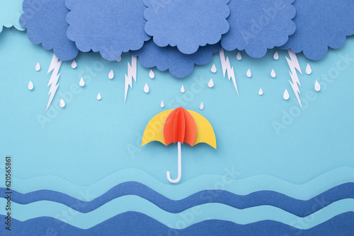 Raindrops with lightning on the sea and umbrella made of paper cut. Monsoon minimal paper art background.