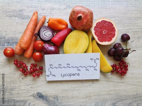 Obraz na płótnie Foods rich in lycopene with structural chemical formula of lycopene molecule