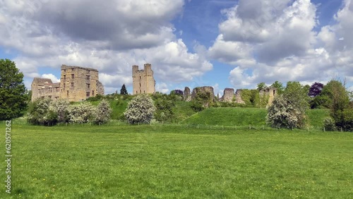 View of the medieval ruins of Helmsley Castle in the stunning North York Moors. The castle sits above a vibrant grass area. Taken on a sunny spring day - North Yorkshire, UK photo