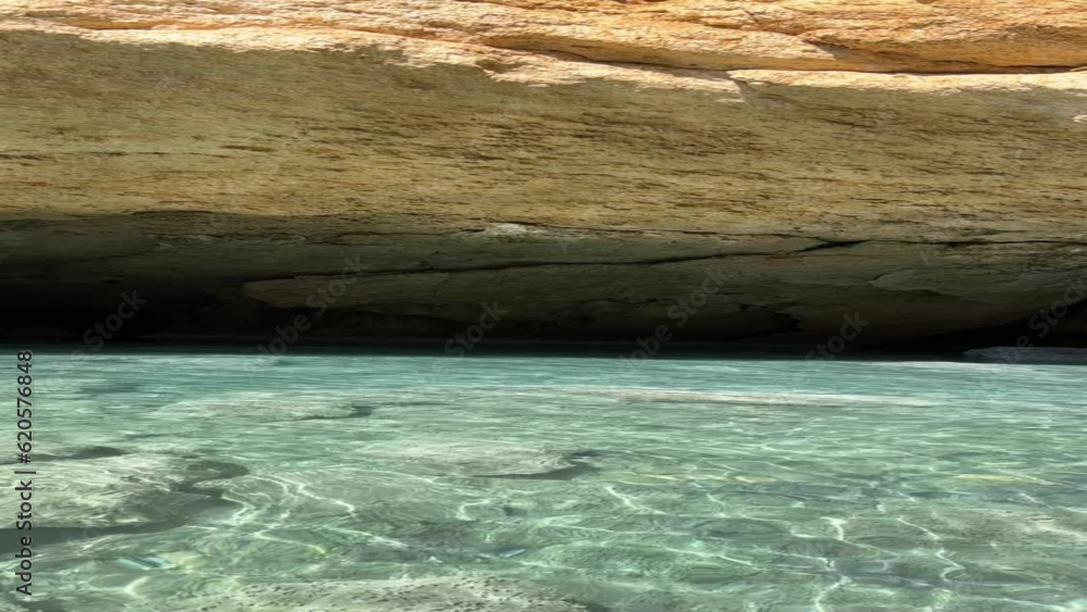 Blue sea, pebble beach, cave, rocks, sky, vertical video. Blue sea, pebble beach, cave, rocks, sky, vertical video.