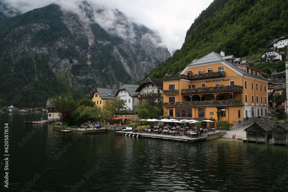 Photo of a serene lakeside town with colorful buildings and boats on the water, Austria