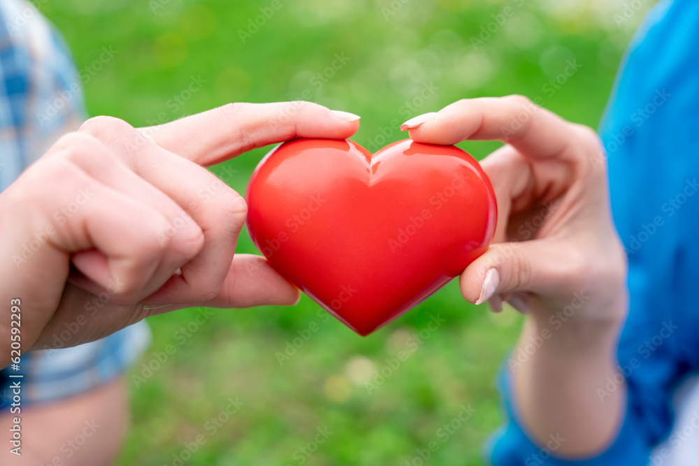Couple holding red heart.Getting together in love concept Couple holding red heart.Getting together in love concept