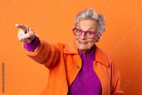 Older woman wearing glasses pointing to the side with her hand in the air. Generative AI.
