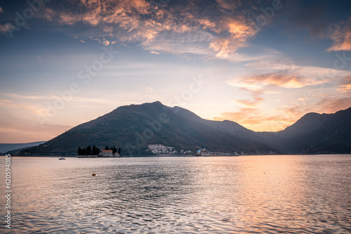 Panoramic view of the picturesque cliffs of the Bay of Kotor near the beautiful town of Perast and islands during the golden hour of sunset, Montenegro.