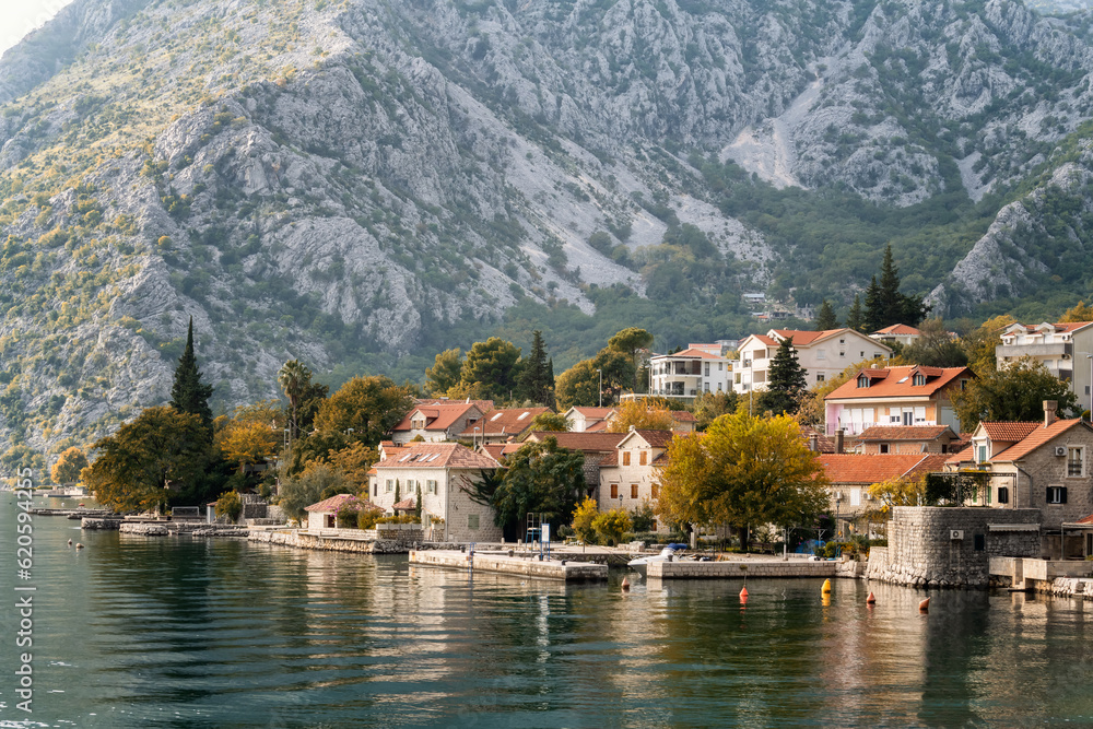 Long shot autumn view of the picturesque town of Perast in the Bay of Kotor with beautiful historic buildings and boats, Montenegro