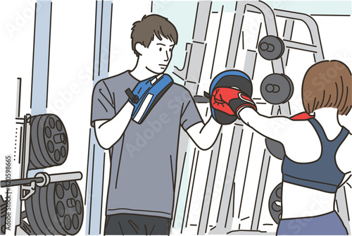 格闘技のパンチをする女性と男性トレーナー