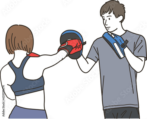 格闘技のパンチをする女性と男性トレーナー
