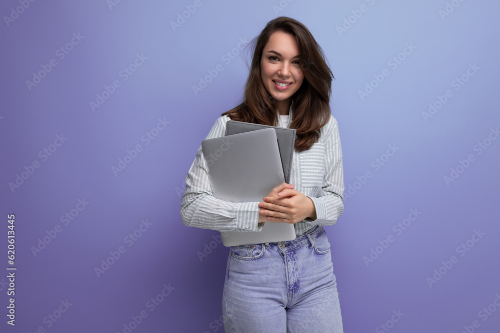 smart successful brunette young lady freelancing with hair below her shoulders with documents and a laptop smart successful brunette young lady freelancing with hair below her shoulders with documents and a laptop
