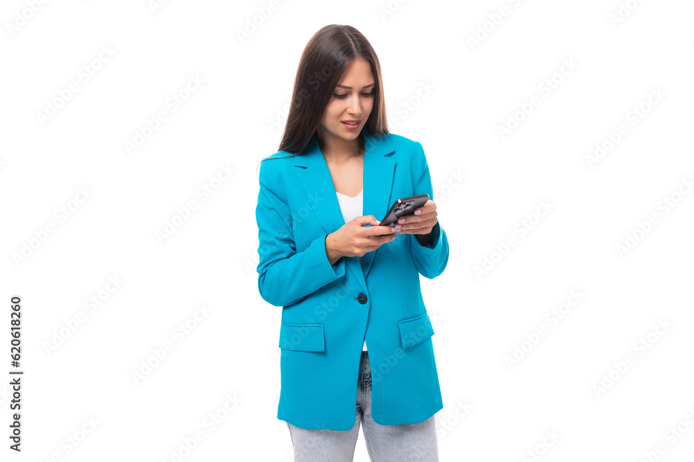 young pleasant brunette leader woman with long hair dressed in a business bow solves work issues in a smartphone online young pleasant brunette leader woman with long hair dressed in a business bow solves work issues in a smartphone online