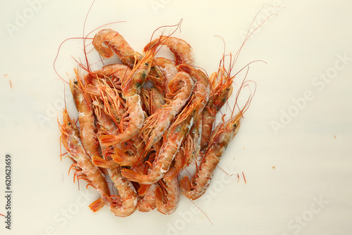 frosted king prawns close up photo on white table background