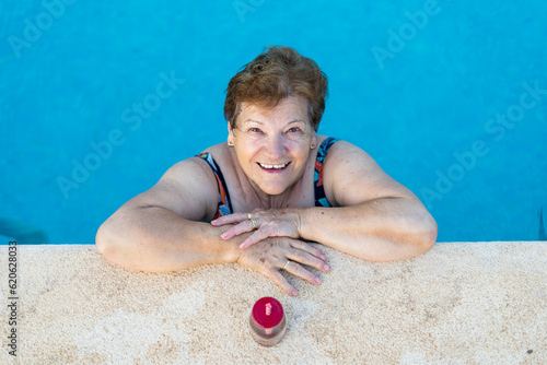 beautiful woman relaxed and happy by the pool