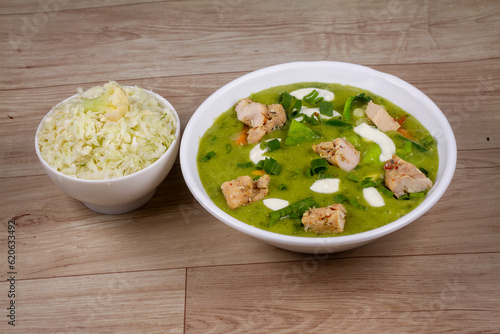Keto Thai chicken Green Curry in white bowl on wooden background