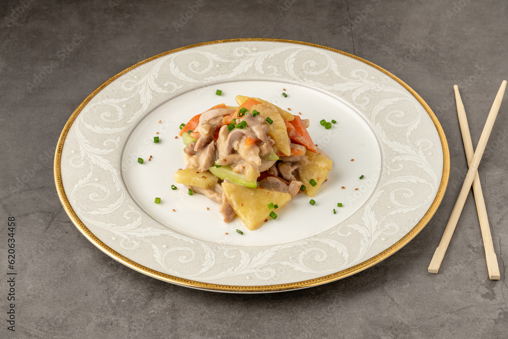 Hot and sour chicken sautéed with carrots, potatoes and zucchini. Asian Cuisine Hot and sour chicken sautéed with carrots, potatoes and zucchini. Asian Cuisine