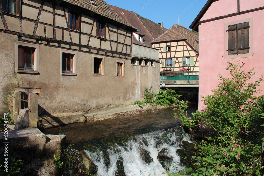 creek and old houses in andlau in alsace (france)