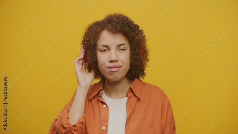 Female Enjoying Music in Headphones on Yellow Background Female Enjoying Music in Headphones on Yellow Background
