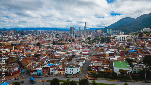 Schilderij op canvas High-rise buildings and city sprawl of Bogota Colombia with Mountain In Backgrou