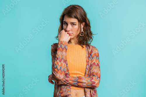 Young Caucasian woman tired bored indifferent expression, exhausted of tedious story, not interested in communication talk, displeasure, uninteresting. Girl isolated on blue studio background indoors